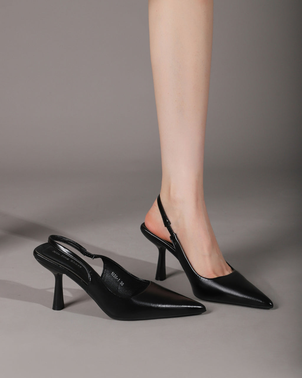Black slingback pumps on-foot pair view
