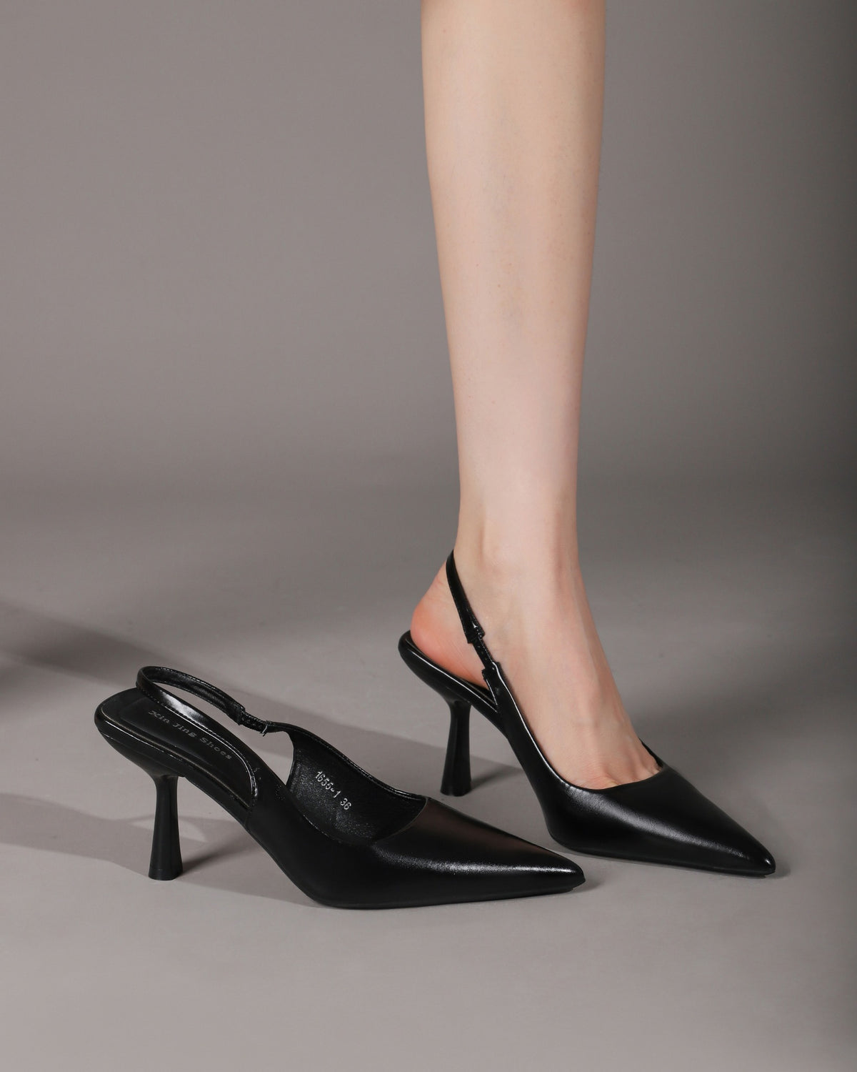 Black slingback pumps on-foot pair view