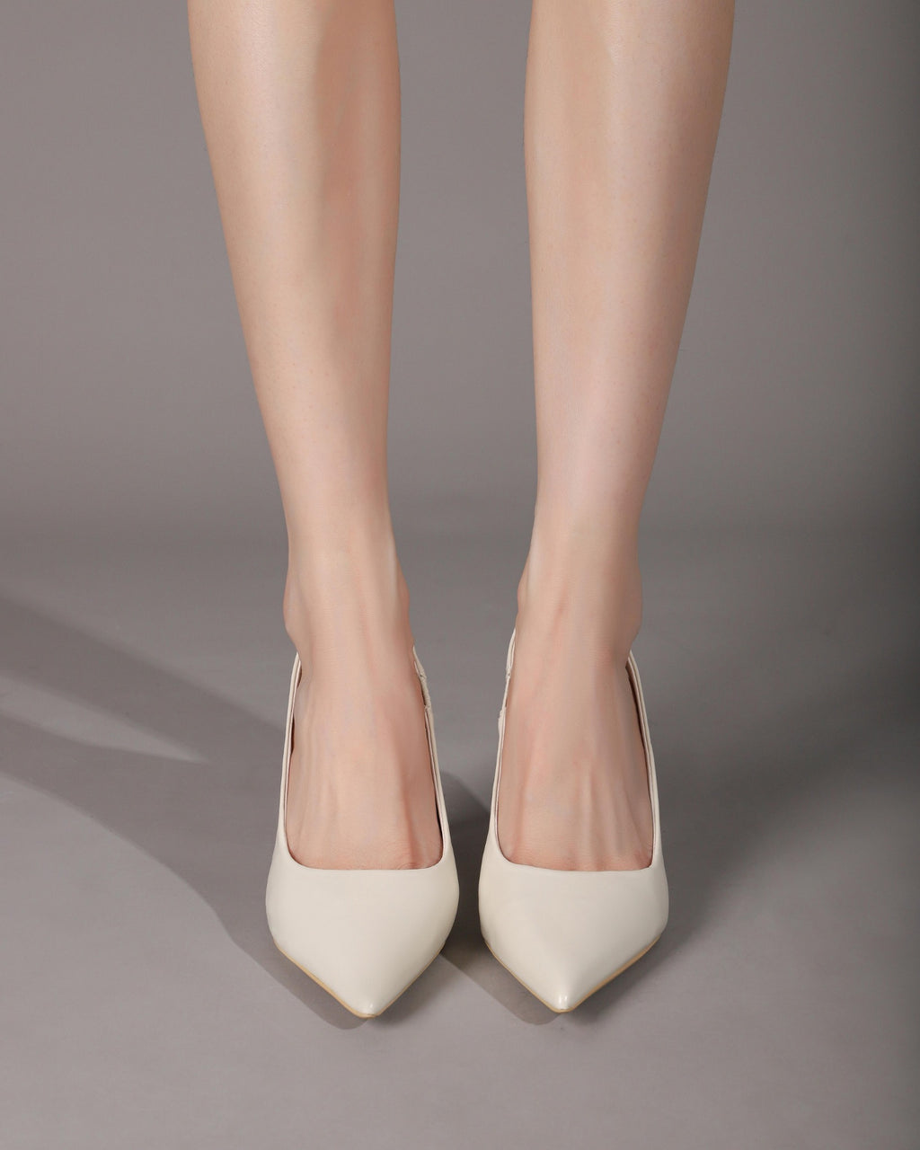 Off-White pointed-toe slingback pumps on foot