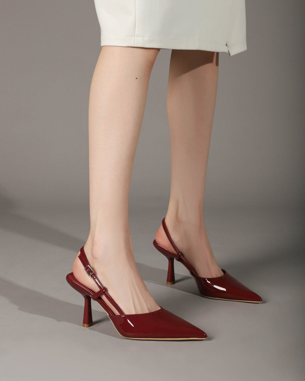 Wine Red patent pointed-toe slingback pumps on foot 3