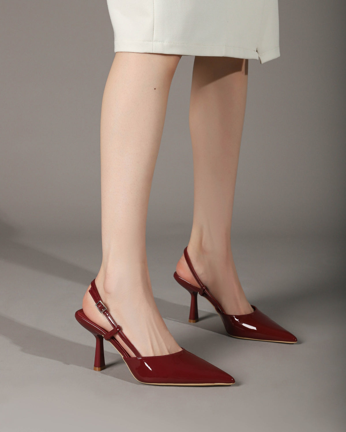 Wine Red patent pointed-toe slingback pumps on foot 3
