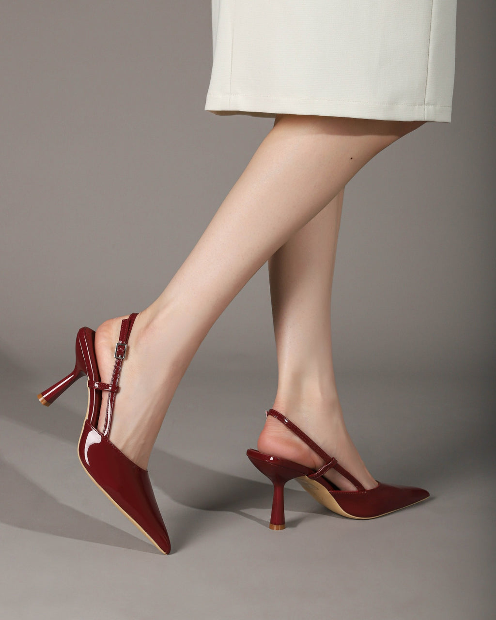 Wine Red patent pointed-toe slingback pumps on foot 4