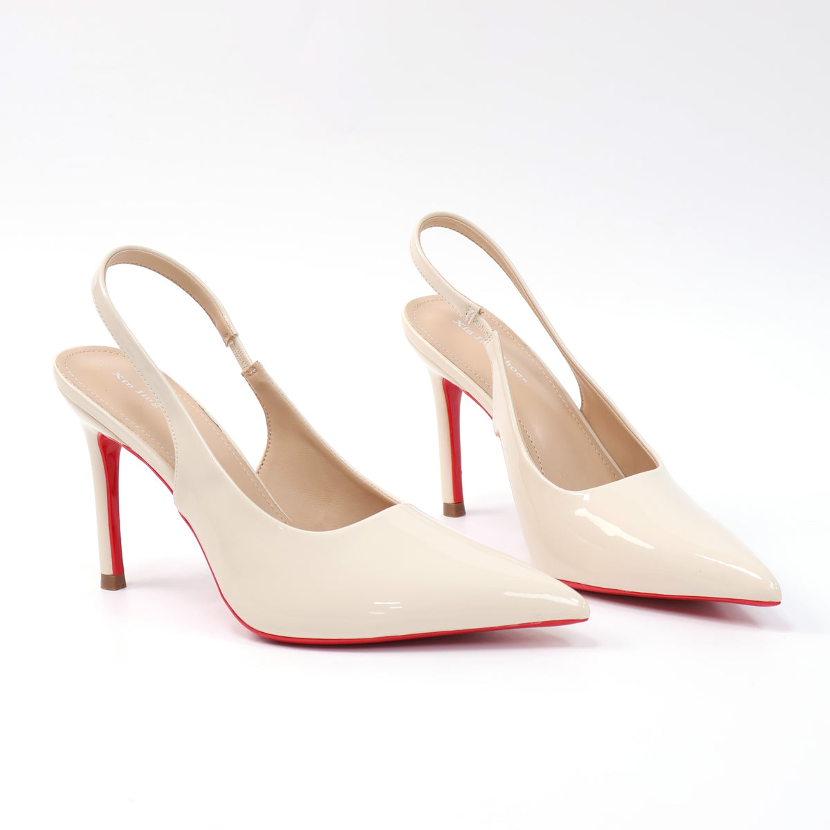 White pointed-toe patent slingback stiletto pumps