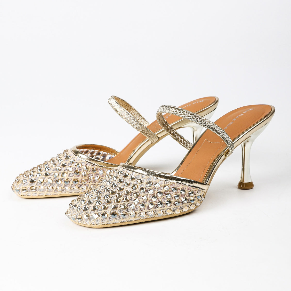 Gold rhinestone mesh heeled mules, pair on white background
