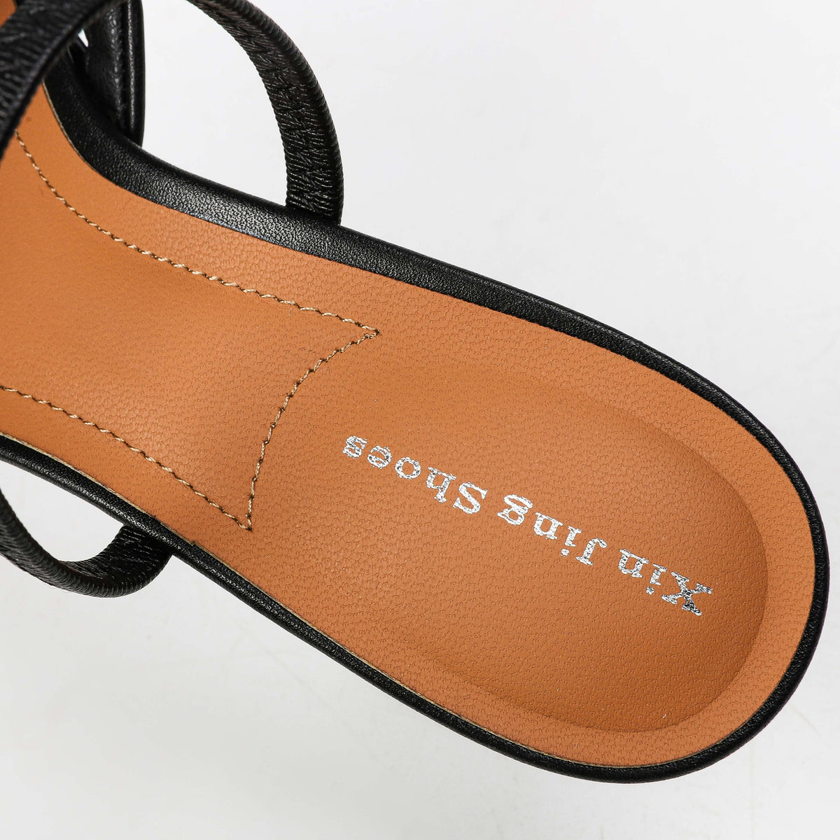 Black heeled mule footbed detail