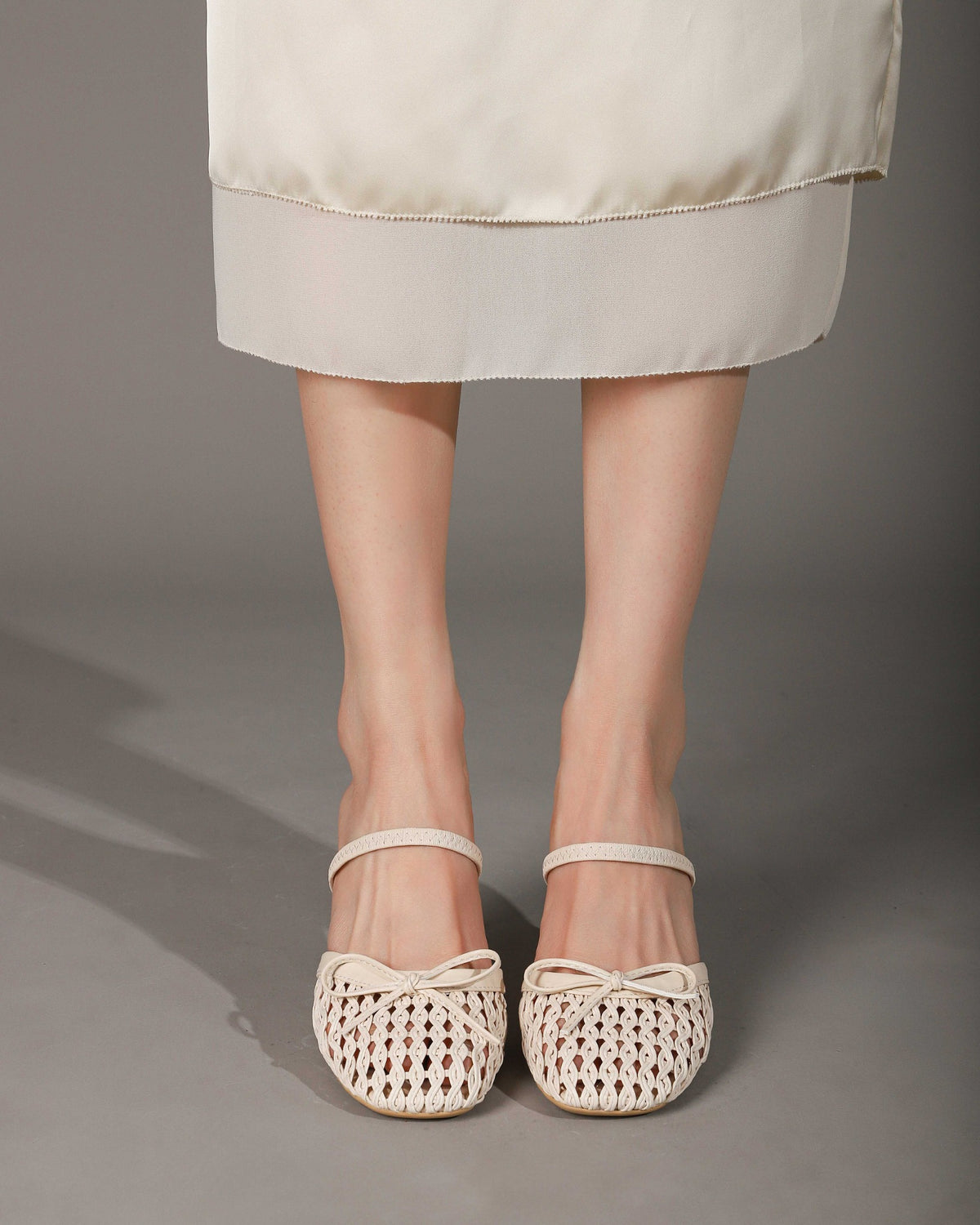 Khaki woven heeled mules worn, front view