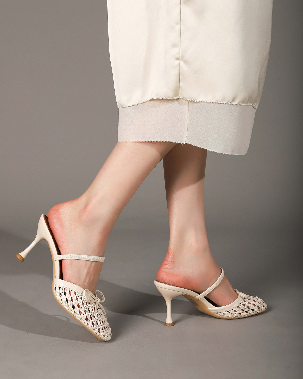 Khaki woven heeled mules worn, side and back views
