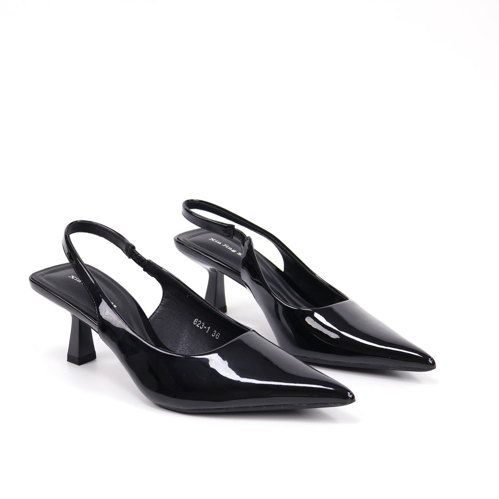 Black pointed-toe patent slingback pumps