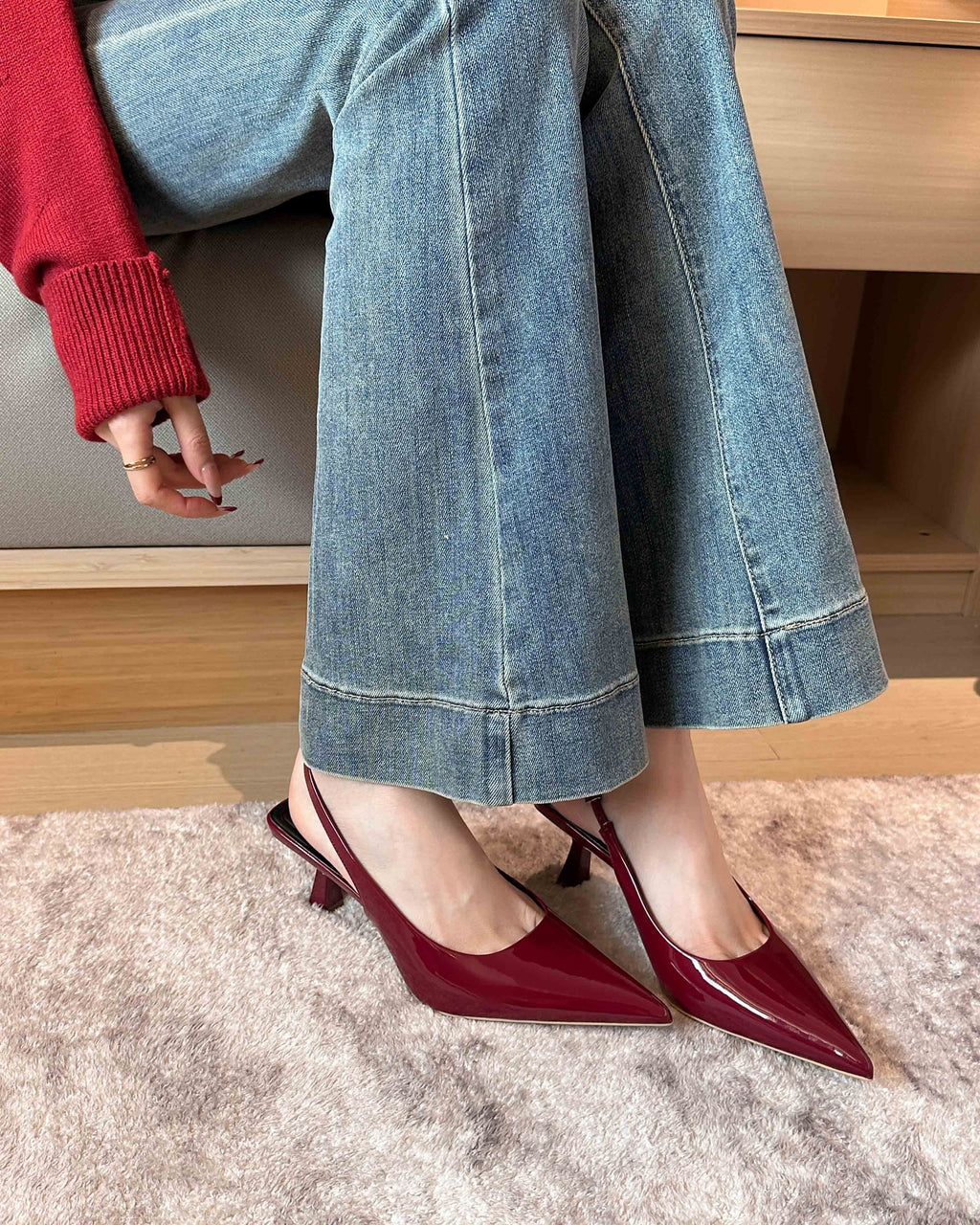 Wine Red pointed-toe patent slingback pumps on foot