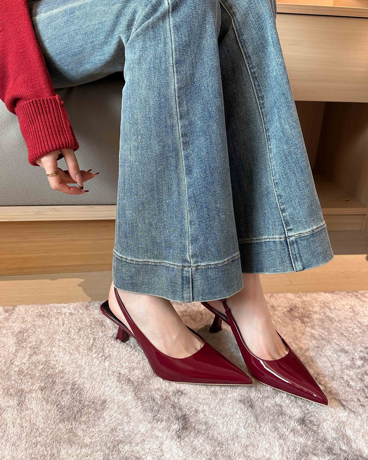 Wine Red pointed-toe patent slingback pumps on foot