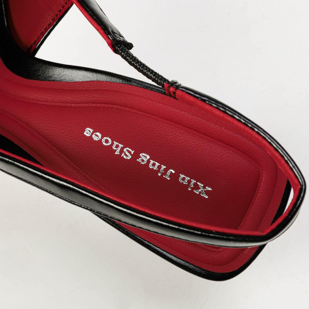 Black slingback heel elastic strap and red footbed detail