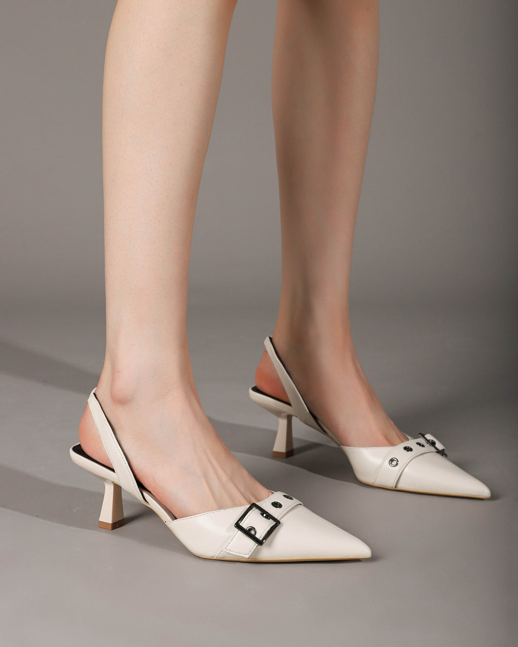 Off-white slingback heels on foot with pair view