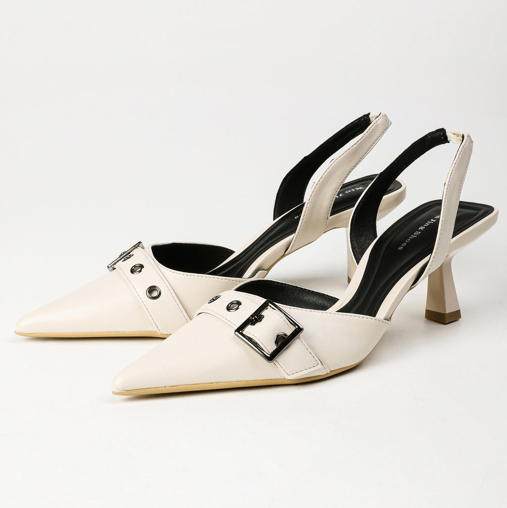 Off-white pointed-toe buckle slingback heels pair front three-quarter view