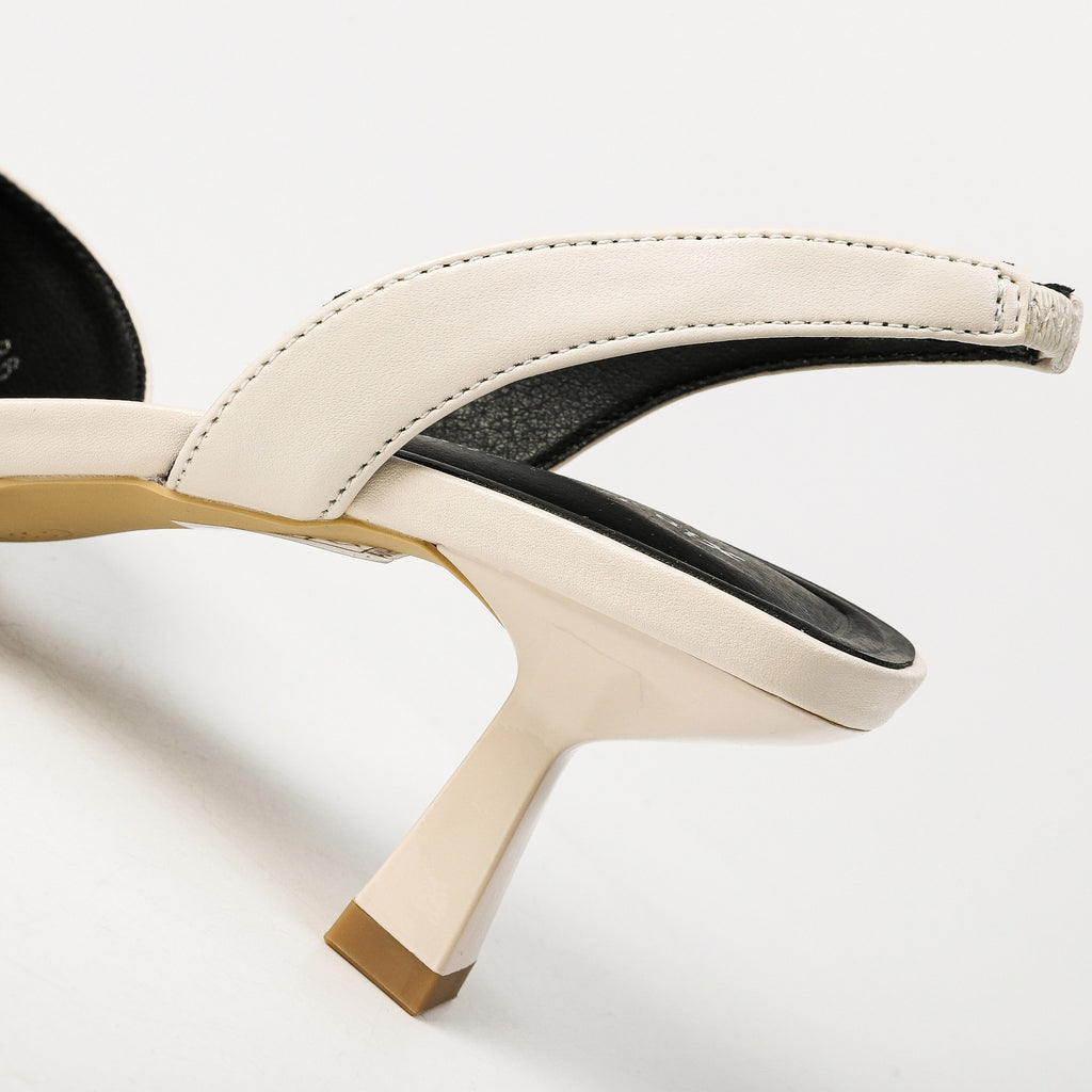 Off-white slingback strap and flared heel close-up