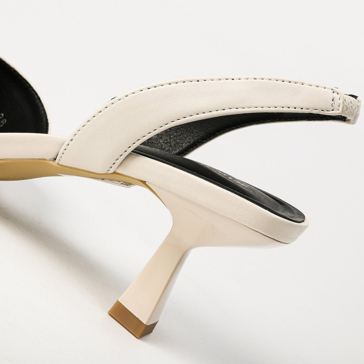 Off-white slingback strap and flared heel close-up