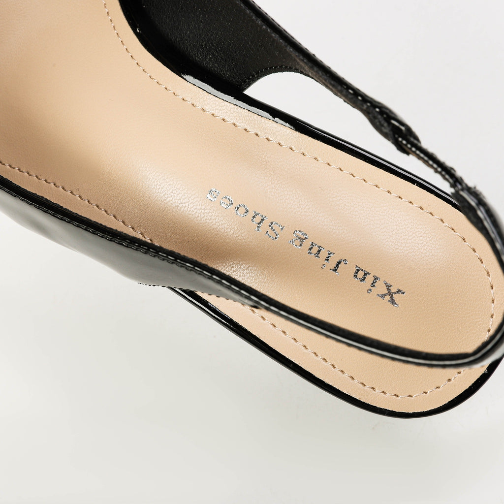 Black pointed-toe slingback heels footbed detail