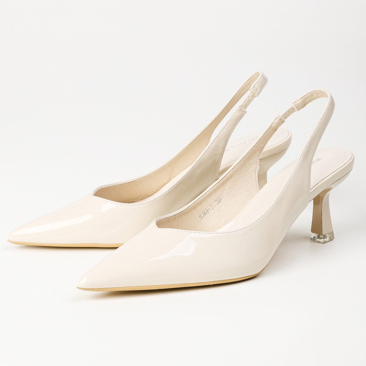 Cream patent pointed-toe slingback heels pair