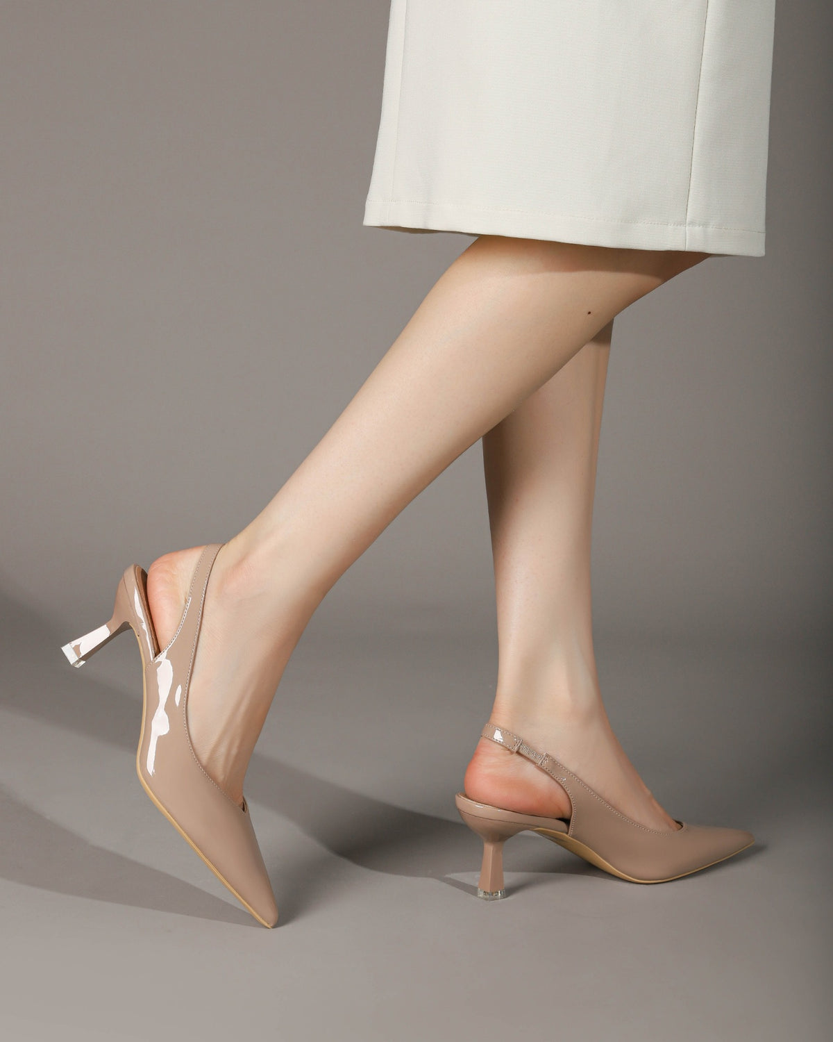 Khaki slingback heels on model pointed toe