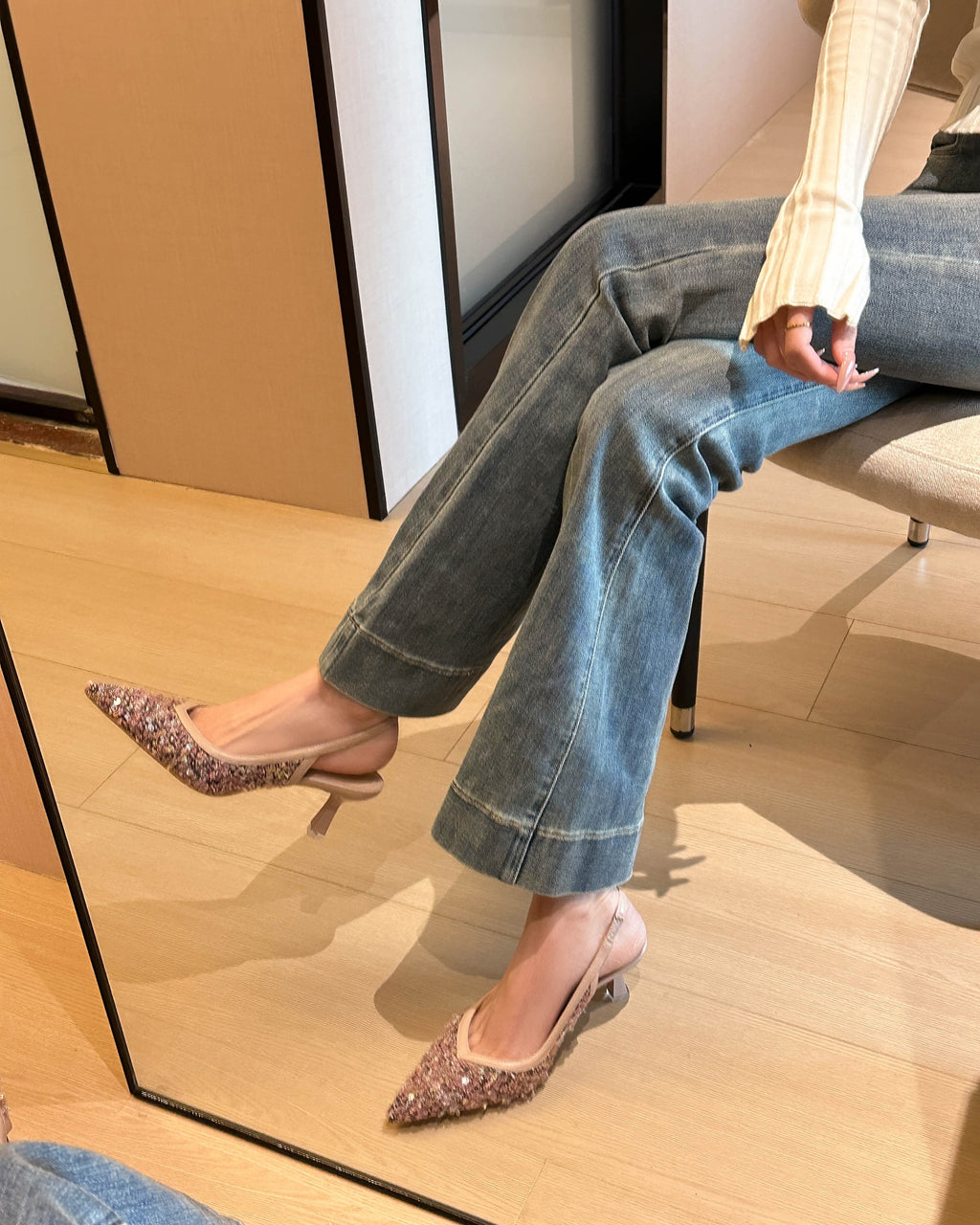 Pink pointed-toe sequin fabric slingback pumps on foot