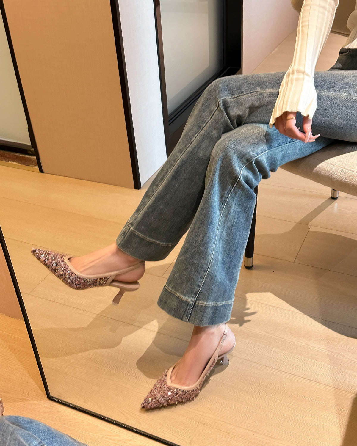 Pink pointed-toe sequin fabric slingback pumps on foot