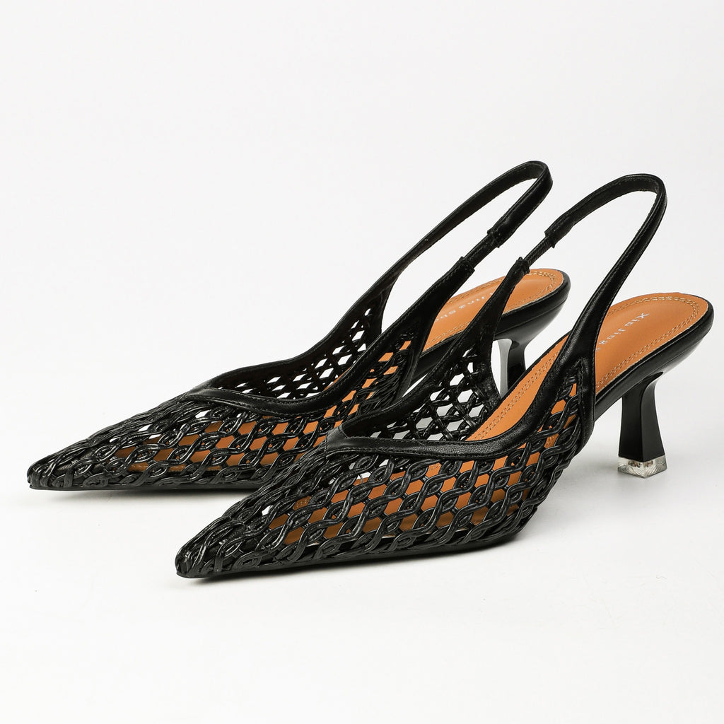 Black pointed-toe woven slingback heels pair front angle
