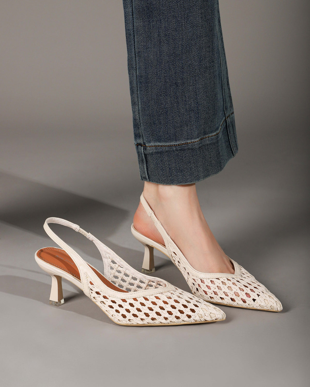 Off-white woven slingback heels styled with jeans side view