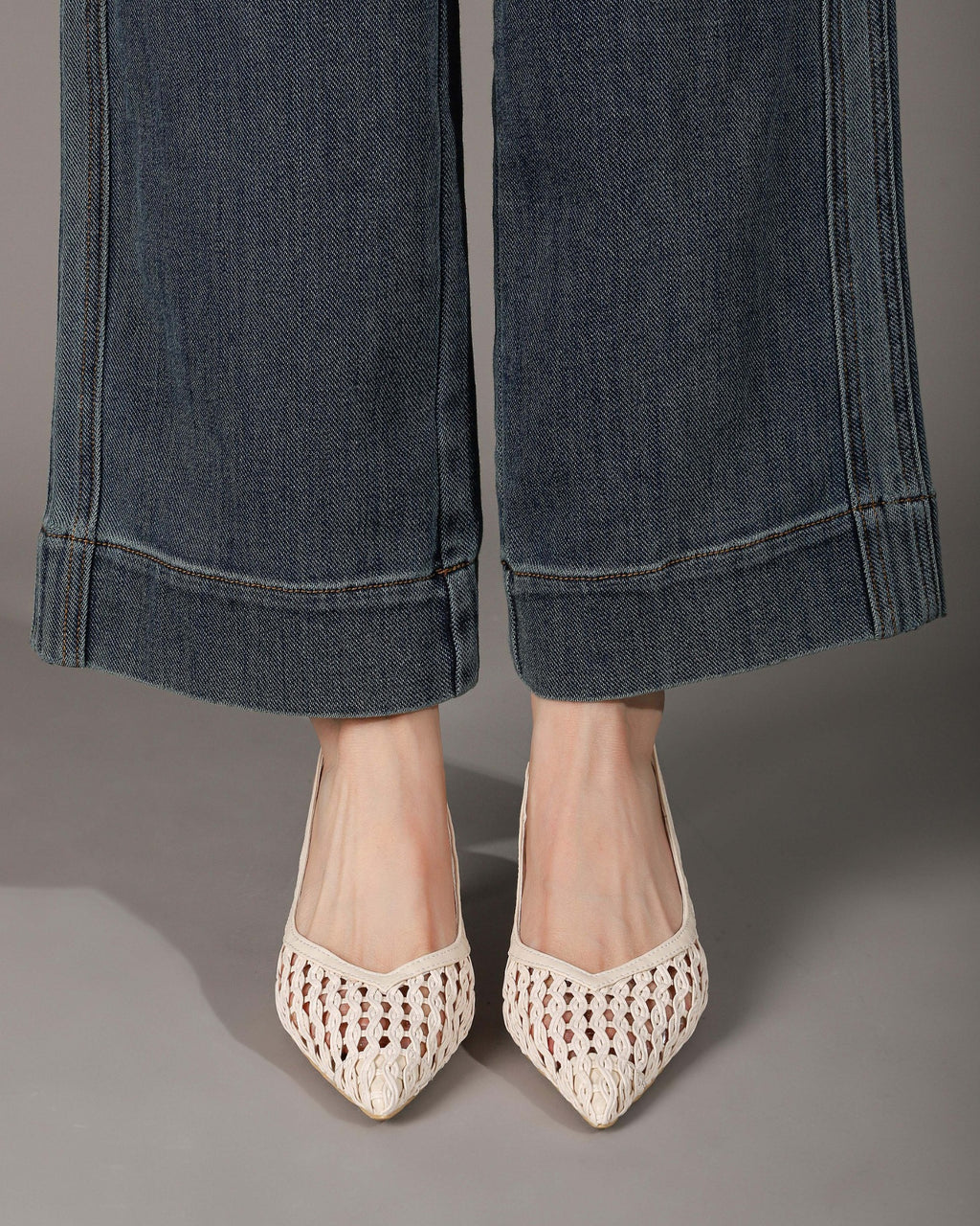 Off-white woven slingback heels on feet front view