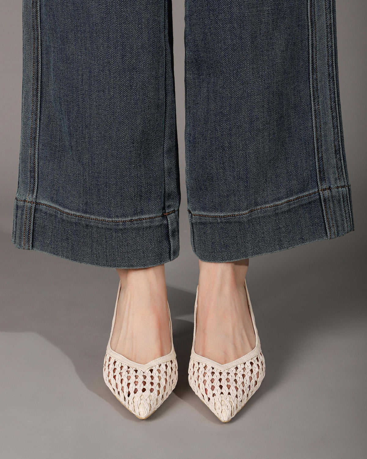 Off-white woven slingback heels on feet front view