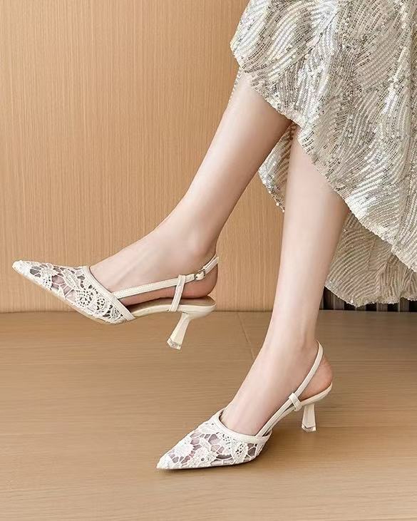 Off-white lace slingback heels worn seated pose