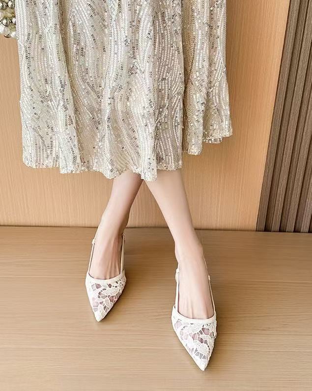 Off-white lace slingback heels worn front pose