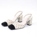 Off-white square-toe polka-dot fabric slingback heels pair front angle