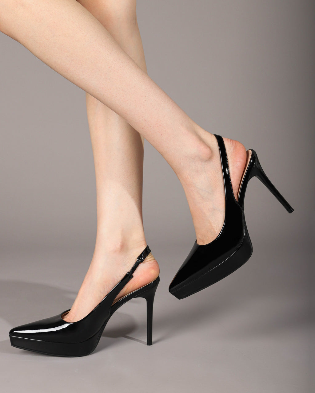 Black platform slingback pumps on foot