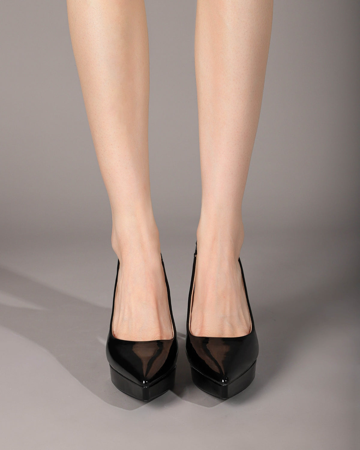 Black pointed-toe pumps front on-foot view