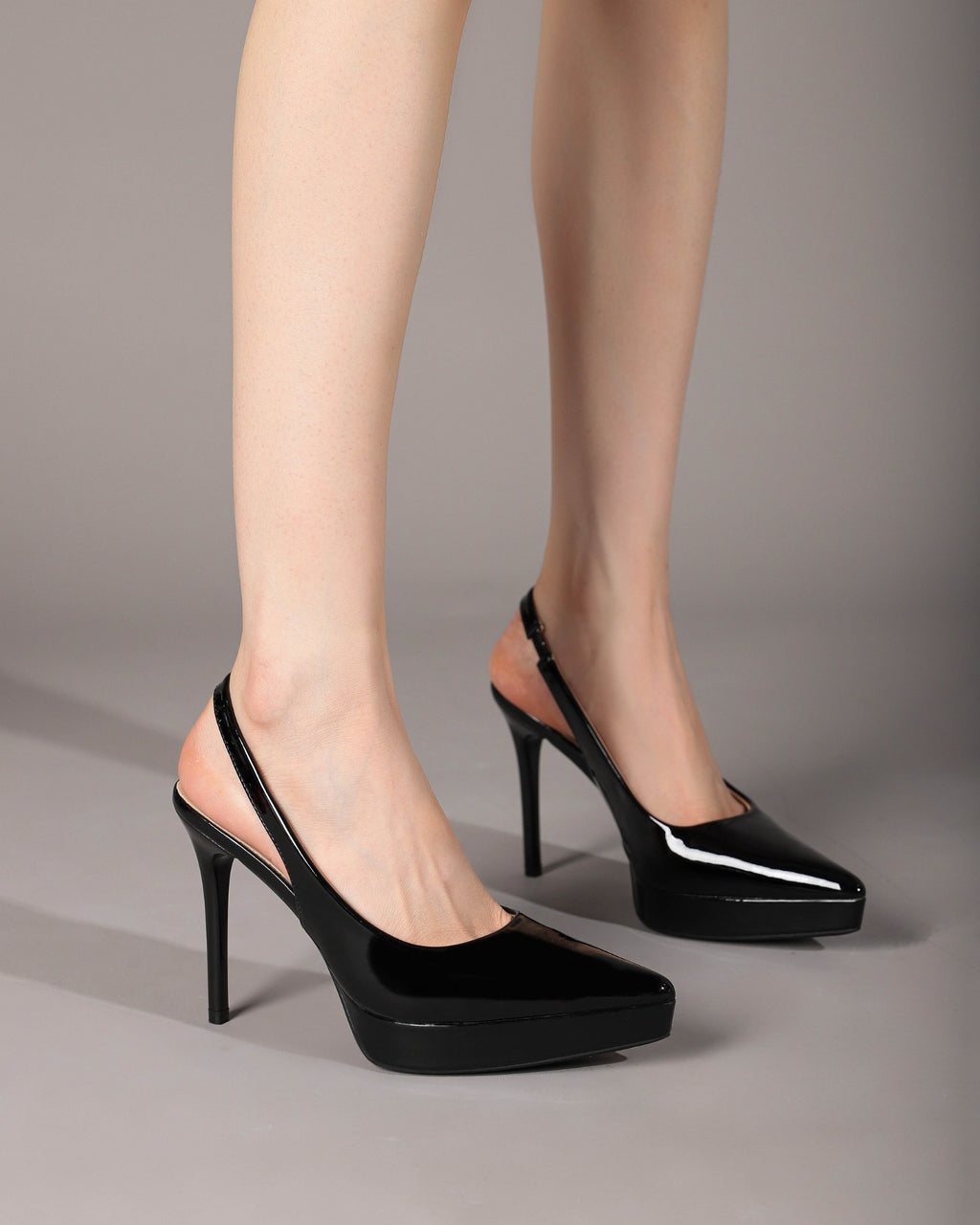 Black slingback stiletto pumps on foot