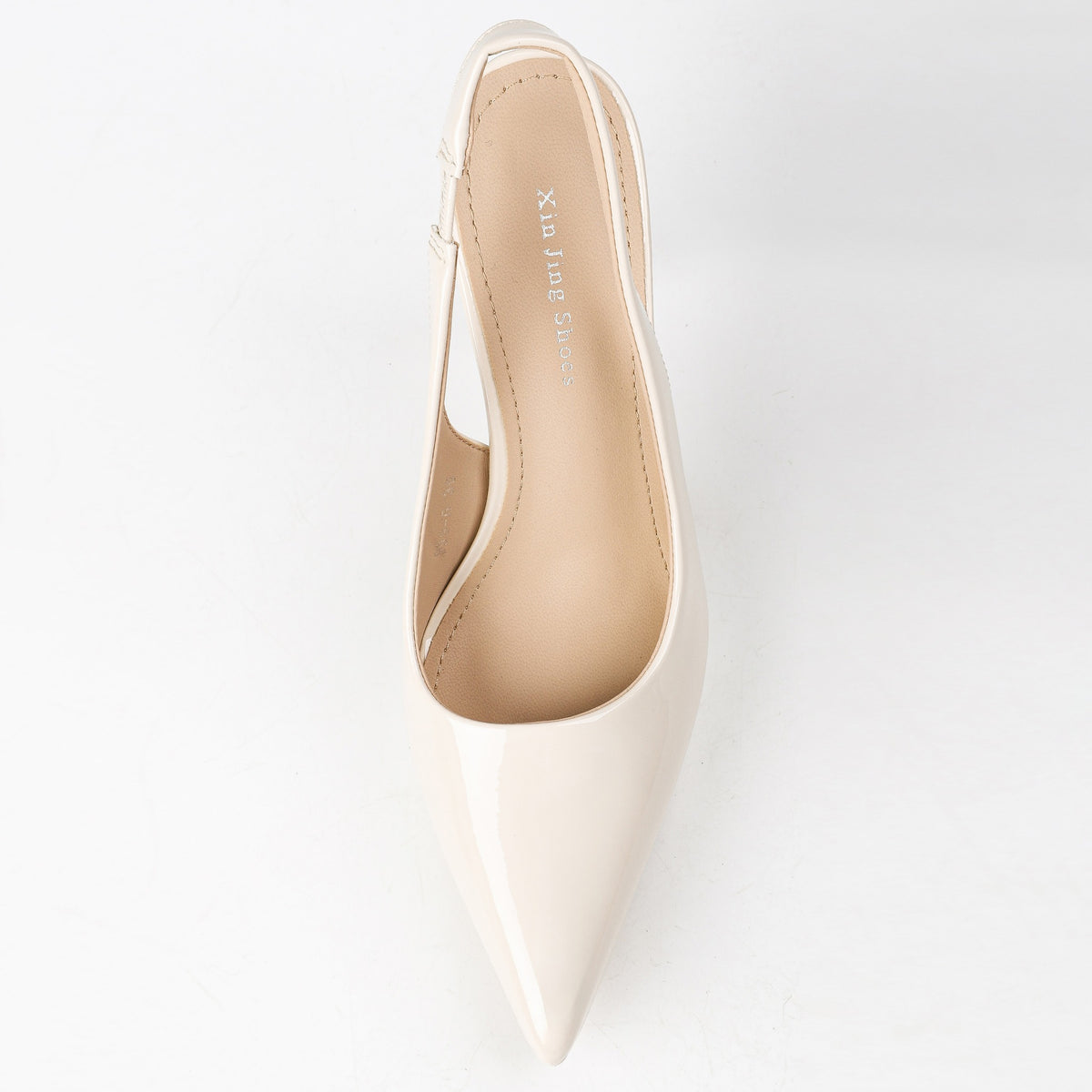 Off-white pointed-toe slingback pumps top view
